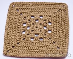 a crocheted square with holes in the middle