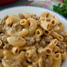 a white plate topped with pasta and meat