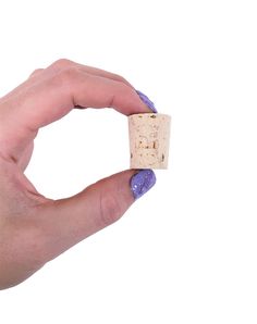 a person's hand holding a wine cork in front of a white background,