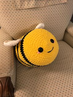 a yellow stuffed animal sitting on top of a chair