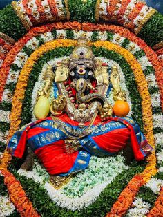 an idol is displayed in the middle of flowers