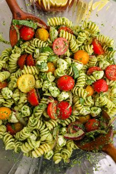 a bowl filled with pasta and vegetables on top of a table