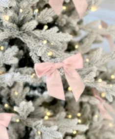 a christmas tree with pink bows and lights