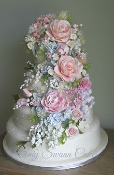 a wedding cake decorated with pink and white flowers