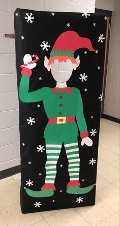 the door is decorated with an elf and snowflakes on it's side