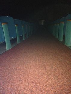 an empty hallway with several urinals lined up on the floor and one in the middle