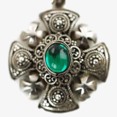 "This ornate Jerusalem Cross pendant is composed of pure silver and features a green cabochon at the center. The pendant has a layered construction with a solid platform topped by convex decorative elements. The surface of the pendant is highly detailed with extensive granulation and wire work and has 4 crosses with brightly polished surfaces at each corner. The pendant comes with its original fan-shaped bail which also bears ornamental granulation and wirework. The back of the bail is fitted wi Silver Emerald Jewelry With Oval Cabochon, Crusader Cross, Decorative Elements, Wire Work, Pure Silver, Spring Rings, Cross Pendant, Cincinnati, Turquoise Ring