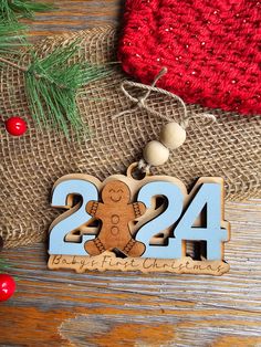 a wooden ornament with the number twenty four and a gingerbread on it