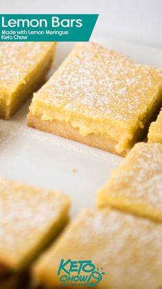 lemon bars on a white plate with powdered sugar and keto - kreme