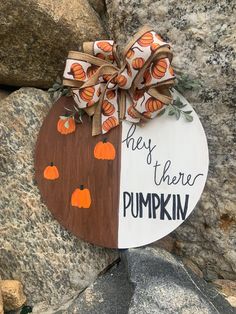 a wooden sign that says, this is where pumpkins are hung on the rocks