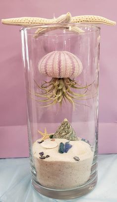 a glass vase with an octopus and other sea creatures in it's bottom shelf