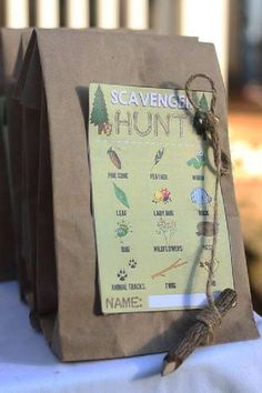 a brown paper bag sitting on top of a table next to a sign that says scavenger hunt