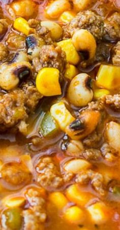 meat and vegetable soup in a bowl with spoon