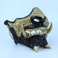 a gold and black mask with horns on it