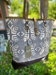 "MYRA Folky Tote Bag s-2819 Embellished with a traditional pattern procured from a handwoven rug, this bag will add a spark to any outfit. 0 Black and white cowhide on front panels Heavy Duty Gray Canvas on bottom & back Leather Handles and leather strap with snap closure Zipper closure. Zipper pocket inside and on back. 2 Additional interior slip pockets Fully Lined Materials: Leather, Hair on Hide & Canvas Width: 18\" Height: 16.5\" Item Depth: 4.25\" Handle: 11\" USPS Priority free shipping t Artisan Hobo Bag With Leather Handles, Artisan Hobo Bag With Leather Handles For Everyday, Artisan Tote Hobo Bag For Travel, Artisan Hobo Tote Bag For Travel, Artisan Tote Hobo Bag For Daily Use, Artisan Hobo Tote Bag For Daily Use, Traditional Hobo Shoulder Bag For Everyday Use, Tote Bag Pattern Leather, Hobo Shoulder Bag