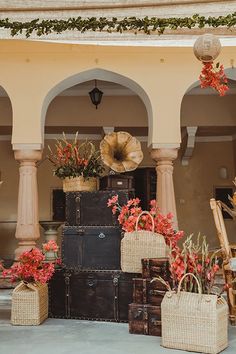 an outdoor area with flowers and baskets on the ground