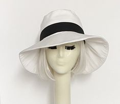 White cotton poly blend twill wide brim sun hat, the crown is 3 1/2 " in length with a black contrast band and a one piece 4" brim, lined in a rayon print with 1" soft black cotton band. One size fits most up to 23" Machine wash / dry Press if needed / packable Made in USA Beret Hat Bow, Black And White Hats, Chanel Hat, Disney Hats, Hat Stores, Wide Brim Sun Hat, Denim Hat, Black Baseball Cap, Black Chevron