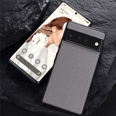 an image of a cell phone case next to it's packaging on a rock