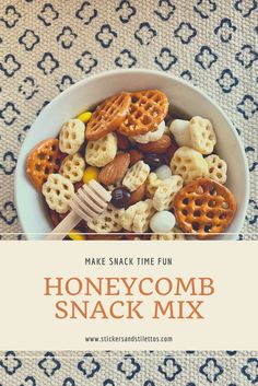 a bowl filled with honeycomb snack mix on top of a blue and white table cloth