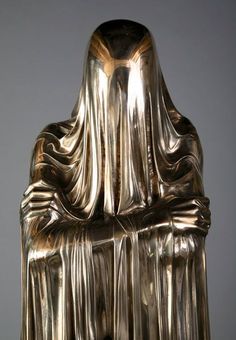 a large golden statue sitting on top of a table