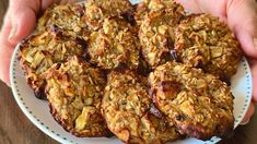 a person holding a plate full of oatmeal cookies