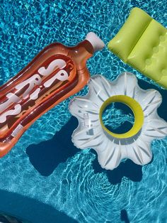 an inflatable pool toy and float next to a swimming pool with blue water