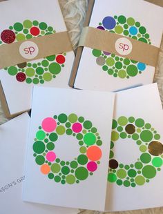 four handmade christmas cards with the letter c on them, each decorated with different colored circles