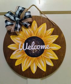 a welcome sign with a sunflower painted on it