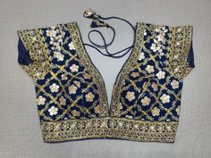 Liven up the festivities with this navy blue colored blouse. Tailored in silk, featuring beautiful embroidery work. Give your festive outfit a dazzling update with this lively navy blue crop top. Featuring all-over mirror embroidery, this top is the perfect match for your solid separates. Buy this designer blouse in the USA from Pure Elegance. - Front View Intricate Embroidered Top For Navratri, Intricately Embroidered Festive Top For Navratri, Festive Top With Intricate Embroidery For Navratri, Mirror Work Tops For Navratri Reception, Mirror Work Tops For Reception Navratri, Navratri Reception Tops With Mirror Work, Mirror Work Tops For Reception And Navratri, Blue Traditional Blouse For Reception, Resham Embroidered Top For Diwali Party