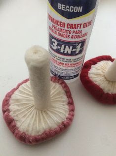 a bottle of glue next to two cleaning sponges on a white counter top with a red and white mop