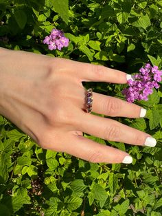 Vintage 9k Swirl Ring Stacker (Natural Amethyst, Garnet, and Iolite) Description: This vintage 9k swirl ring stacker features natural amethyst, garnet, and iolite stones, making it a unique and trendy addition to your jewelry collection. Sized at 5 3/4 (almost a 6) and weighing 2.02g, this ring showcases English hallmarks and is perfect for stacking and creating a personalized look. As with all our pieces, this ring is a rare find—once it's gone, it's gone. Choosing this piece helps you stand ou Classic Gold Amethyst Multi-stone Ring, Heirloom Multi-stone Amethyst Ring In 14k Gold, Elegant Multi-stone Amethyst Collectible Ring, Antique Gold Amethyst Multi-stone Ring, Vintage 14k Gold Multi-stone Amethyst Ring, Iolite Stone, Swirl Ring, Vintage Inspired Design, Turks And Caicos