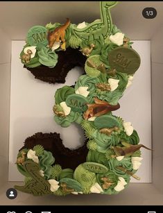 the number three is made out of cupcakes and decorated with green icing