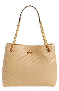 Quilted leather elevates this structured tote bag detailed with stacked-T logo hardware and two chain shoulder straps. A spacious interior with a center divider zipper pocket helps keep all your tech and small essentials organized. Shoulder straps Lined Leather Imported Elegant Tan Shoulder Bag With Zipper, Structured Tote Bag, Tory Burch Kira Chevron, Kira Chevron, Tory Burch Kira, Quilted Leather, Shoulder Straps, Zipper Pocket, Tory Burch