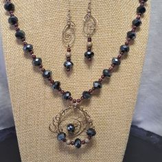 This 21" Necklace Has So Much Sparkle With The Black Faceted Beads That Have A Beautiful Blue Hue. They Are Accented With Small Burgundy Round Beads And Tiny Silver Beads. There's A 2 1/4" Extension And A Hand Crafted Sterling Silver Wire Closure. The Center Hanging Pendant Is Wire Wrapped Sterling Silver Wire With Some Of The Sparkling Faceted Beads And Measures 1 3/4". Matching Pierced Earrings Measure 2" With Sterling Silver Wire Wrap And The Matching Beads. They Hang From Sterling Silver Fre Black Round Beads Jewelry Set As Gift, Black Round Beads Jewelry Set For Gift, Costume Jewelry With Black Round Beads, Black Jewelry Set With Round Beads As A Gift, Black Jewelry Set With Round Beads For Gift, Black Beaded Necklace With Dangling Beads As Gift, Hematite Black Beads For Jewelry Making, Black Metal Beads For Jewelry Making, Faceted Metal Beads Jewelry Gift