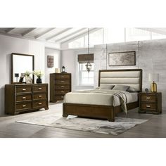 a bedroom scene with focus on the bed and dressers, mirror and nightstand set