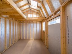 an empty room with wooden framing on the walls