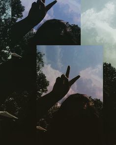 the person is holding their hand up in front of some trees and blue sky with white clouds