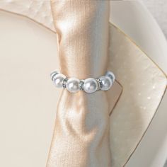 a white napkin with silver beads on it