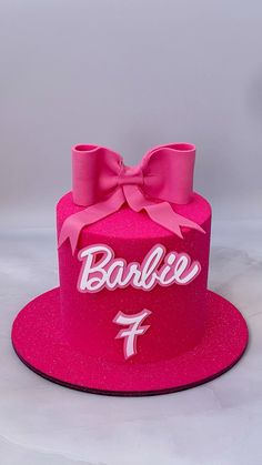 a pink cake with a bow and name on it