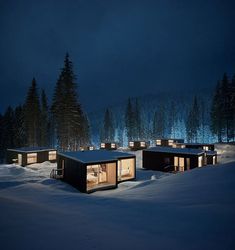 the cabin is lit up at night in the snow