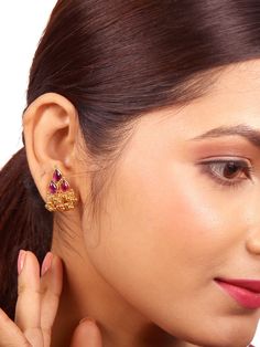 The vintage and ethnic-inspired Siya stud is meticulously crafted from 925 silver, boasting a lustrous gold-polished finish. Its exquisite design features intricate drop motifs, adorned with vibrant red kemp, and adorned with a delightful cluster of dangling ball charms. This Siya stud effortlessly infuses any attire with a timeless and elegant charm. Please refer to the pictures of the jewelry worn on a model to get a clear idea of the size. Condition: New. This product is intricately designed Heavy Ornate Jhumkas, Gold Ruby Jhumkas With Intricate Design, Diwali Ruby Jewelry, Traditional Red Filigree Earrings, Meenakari Ruby Jewelry, Ceremonial Ruby Earrings For Diwali, Traditional Hallmarked Jhumkas, Diwali Hallmarked Jhumkas, Meenakari Teardrop Jewelry