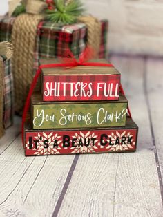 three small wooden blocks with christmas sayings on them sitting next to twine baskets