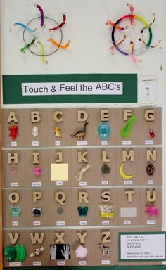 a bulletin board with letters and magnets attached to it's sides that are labeled touch & feel the abc's