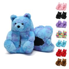 a blue teddy bear sitting next to several pairs of baby booties