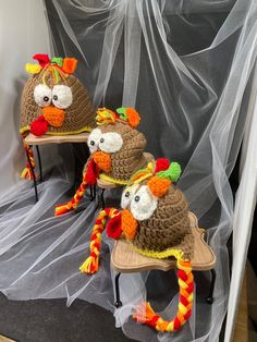 three knit turkey hats sitting on top of chairs