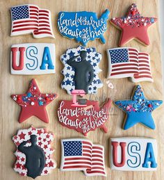 decorated cookies are arranged in the shape of stars and stripes on a wooden table top