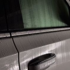 a car door with rain drops on it