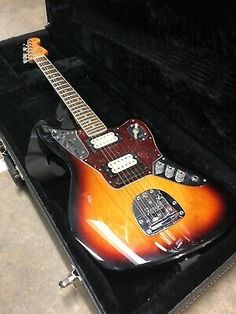 an electric guitar in a case on the floor