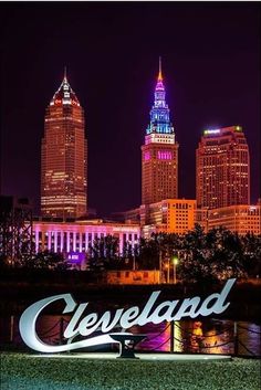 the cleveland skyline is lit up at night