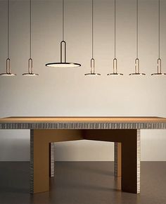 a table with four lights hanging from it